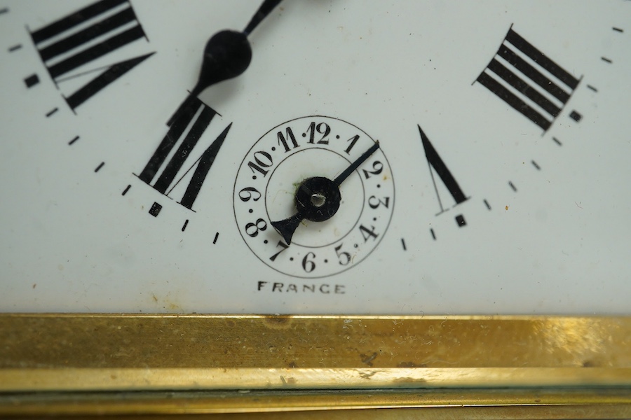 A cased French brass carriage timepiece with alarm, 12cm high